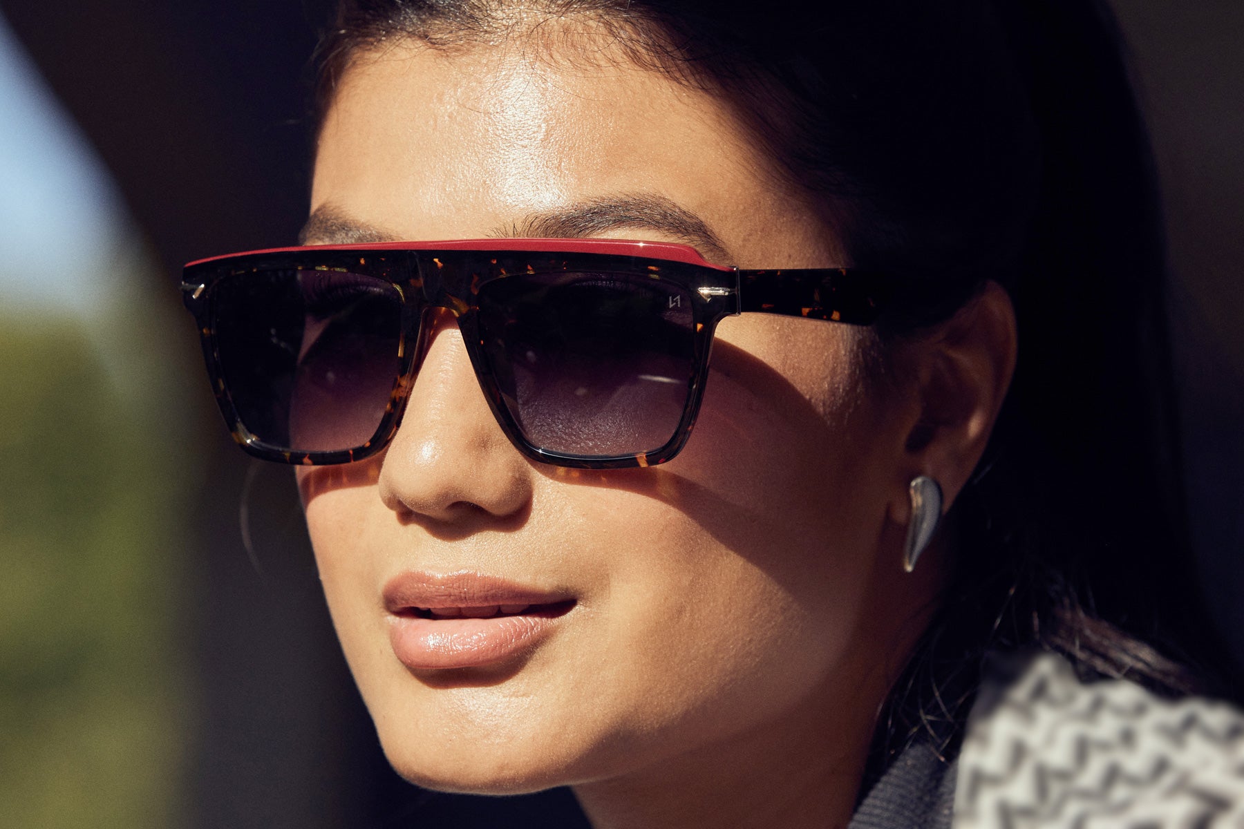 Woman wearing a stylish visor shaped Sunglass