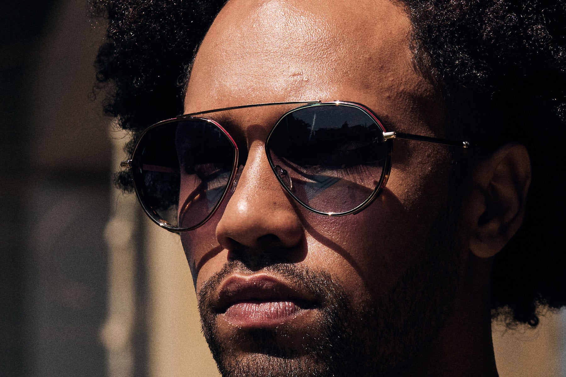Man wearing trendy Pilot Sunglass with Red Details