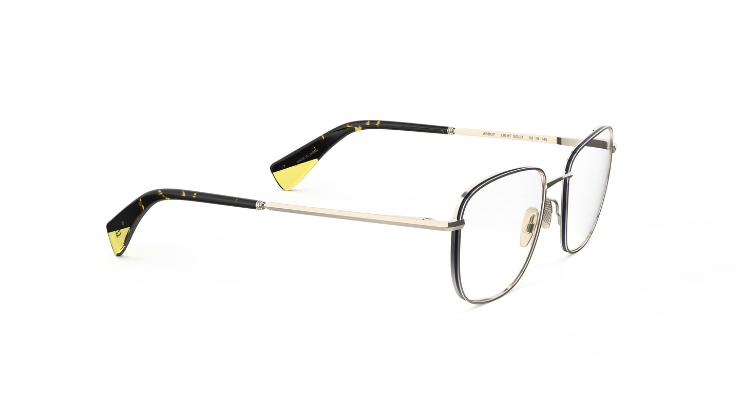 A pair of gold titanium eyeglasses, featuring a light gold frame and dark tortoiseshell temple tips with yellow accents. Integrated spring hinges and nosepads.