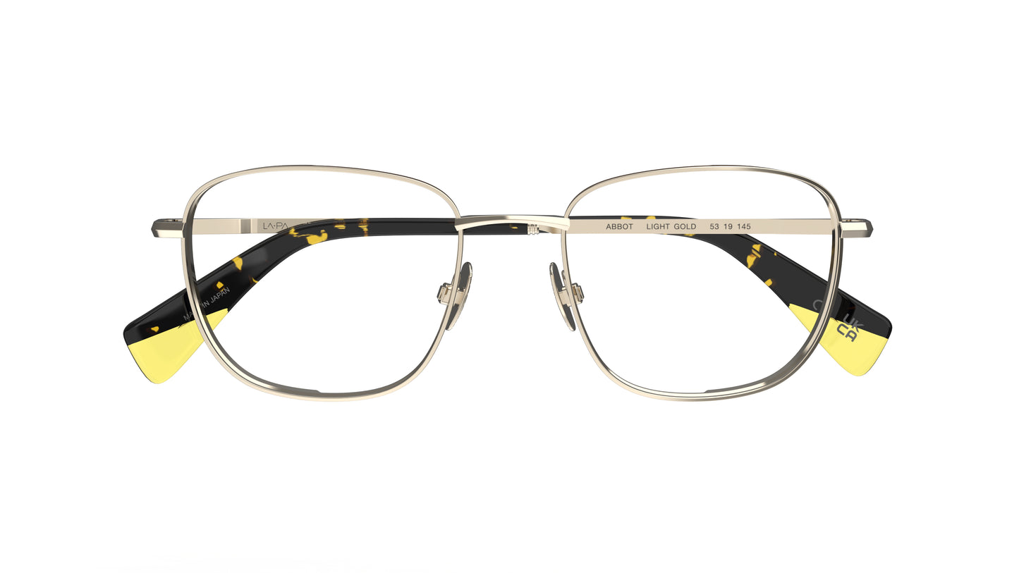 A pair of gold titanium eyeglasses with nosepads, yellow and tortoiseshell temple tips, shown against a plain white background.
