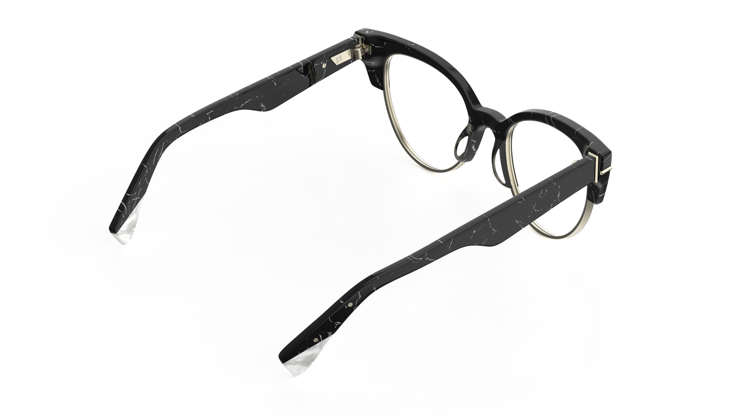 A rear view of a black and white marble cateye frame eyeglasses with silver metal rims, shown on a plain white background.