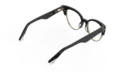 A rear view of a black and white marble cateye frame eyeglasses with silver metal rims, shown on a plain white background.