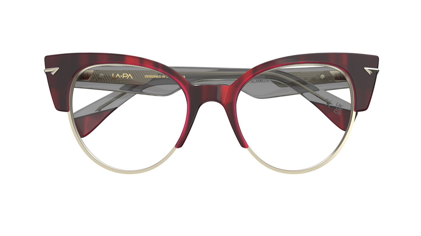 A pair of women's cat-eye eyeglasses featuring a dark red merlot color with light gold metal rim and sculpted metal rivets.