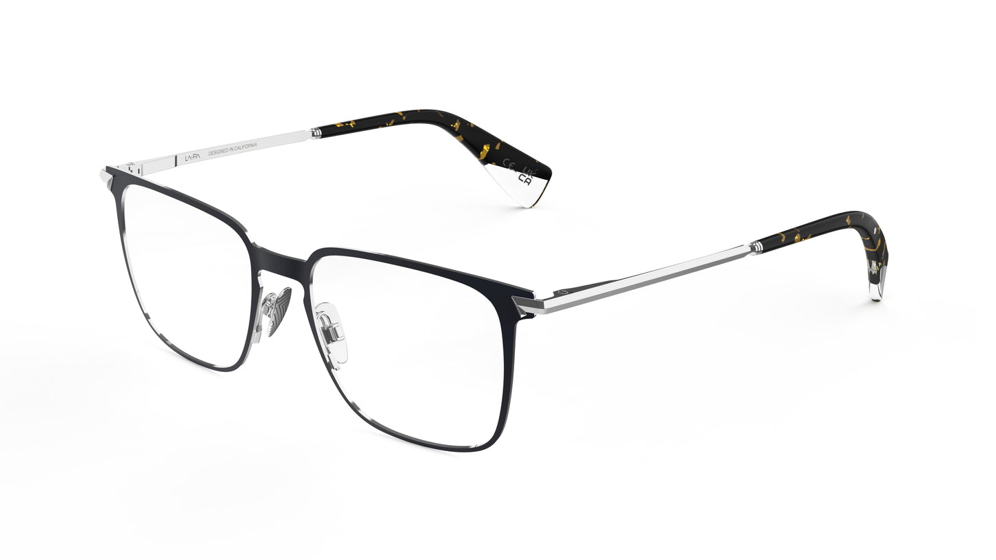 A pair of modern square-frame titanium eyeglasses with a navy front frame, silver titanium temples, and acetate temple tips with an integrated spring hinge, shown on a plain white background.