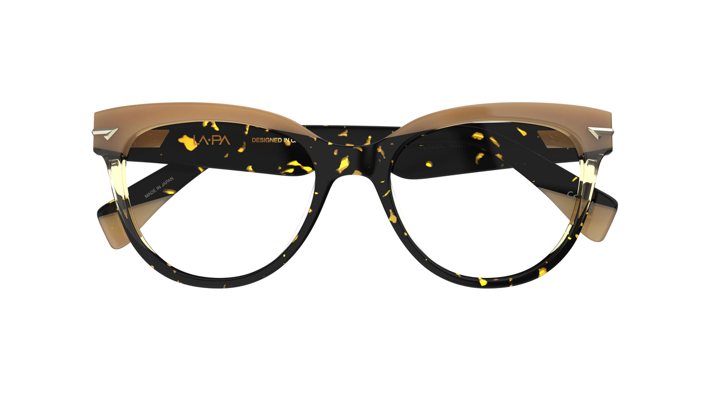 A pair of designer cat-eye ceyeglasses featuring a tortoiseshell acetate front with with a tan brow accent, shown against a plain white background.