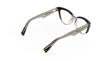A pair of cat-eye eyeglasses featuring a translucent warm gray acetate front, a tortoiseshell upper brow, and burgundy accents with metal wire cores shown from a rear angle on a white background.