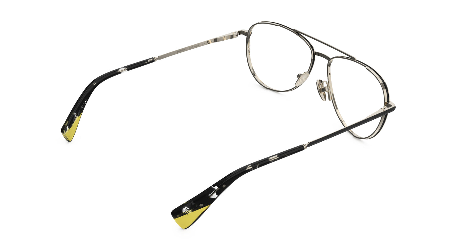 Rear view of aviator-style eyeglasses with light gold titanium construction, and dark tortoiseshell temple tips with yellow accents, integrated spring hinge shown on a plain white background.