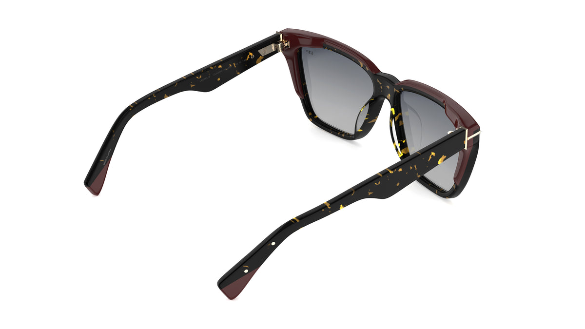 Rear view angle of sunglasses with dark tortoiseshell frames featuring burgundy laminations, dark gray polarized lenses, and metal hinge accents, shown on a plain white background.