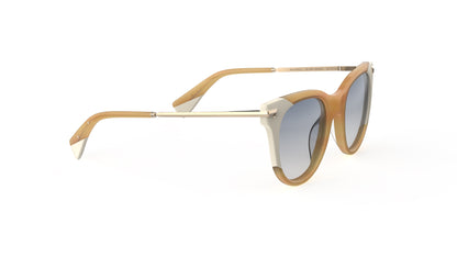 A pair of cat-eye sunglasses with a blond havana and cream acetate frame, light gold titanium temples, integrated spring hinge, and polarized gradient gray lenses, shown on a plain white background.