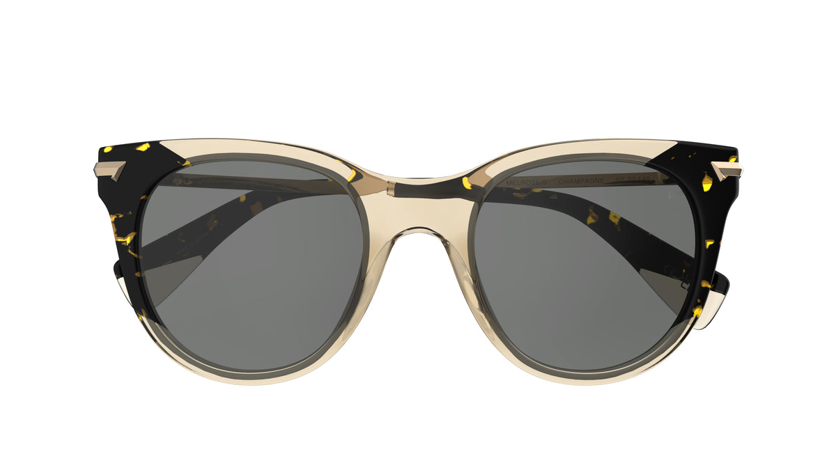 A pair of cat-eye sunglasses with a translucent champagne and tortoiseshell frame and polarized gray lenses, shown against a plain white background.