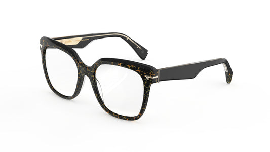 A pair of oversized square acetate eyeglasses featuring a black, brown, and gold tortoiseshell pattern on the front with solid black temples, shown on a plain white background.
