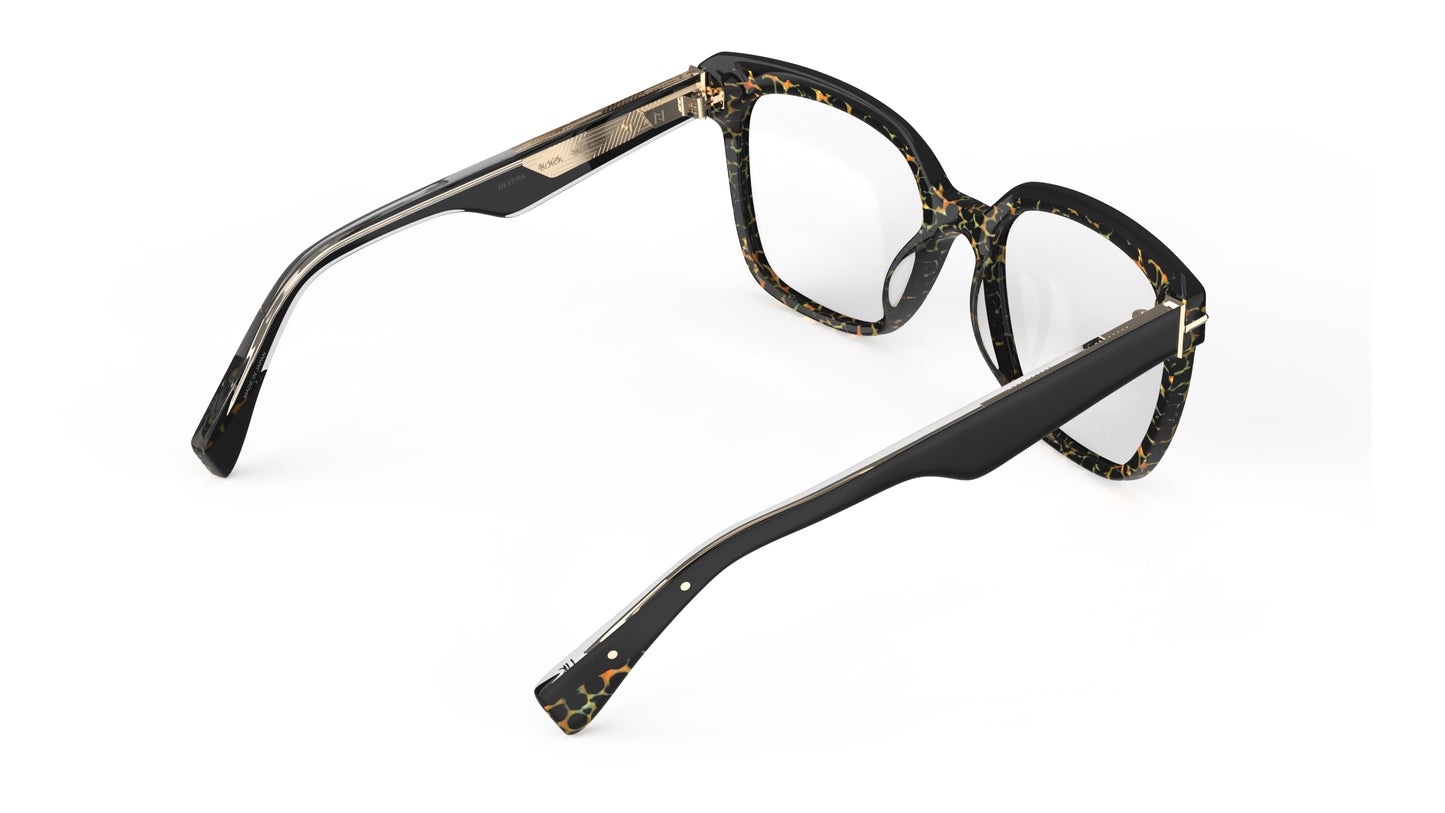 Rear view of a pair of oversized square acetate eyeglasses featuring a black, brown, and gold tortoiseshell pattern on the inside front and solid black temples, shown on a clean white background.