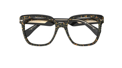 A pair of oversized square acetate eyeglasses with a black, brown, and gold tortoiseshell pattern, shown against a plain white background.