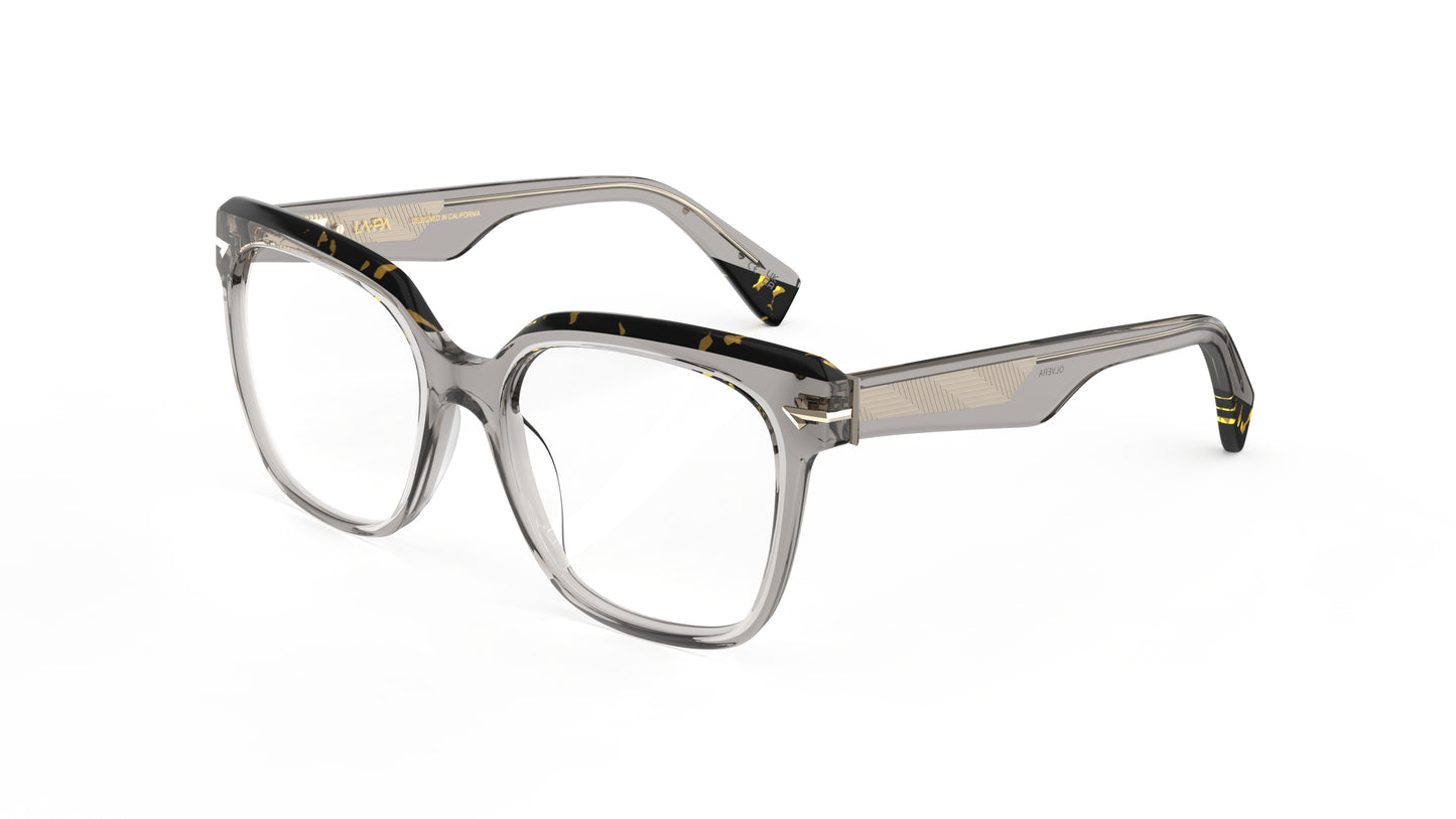 A pair of oversized square eyeglasses with a translucent warm gray acetate frame with a geometric patterned metal wire core, shown on a plain white background.
