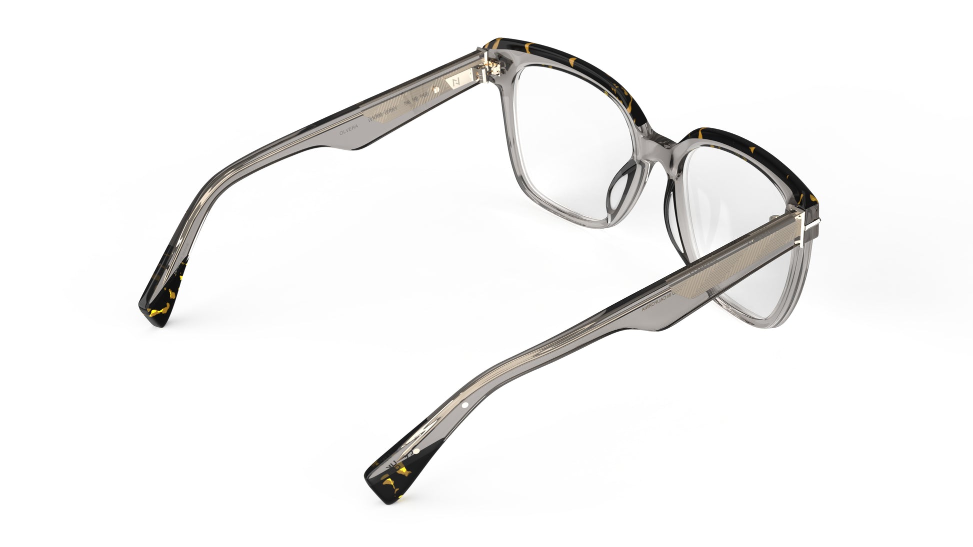 A rear view of a pair of oversized square eyeglasses with a translucent warm gray acetate frame with tortoiseshell top rims with a metal wire core, shown on a plain white background.