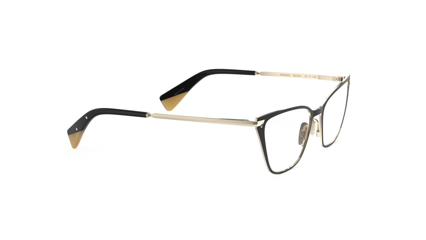 A pair of angular cateye eyeglasses with a black titanium front and gold titanium temples with an integrated spring hinge, shown on a plain white background.