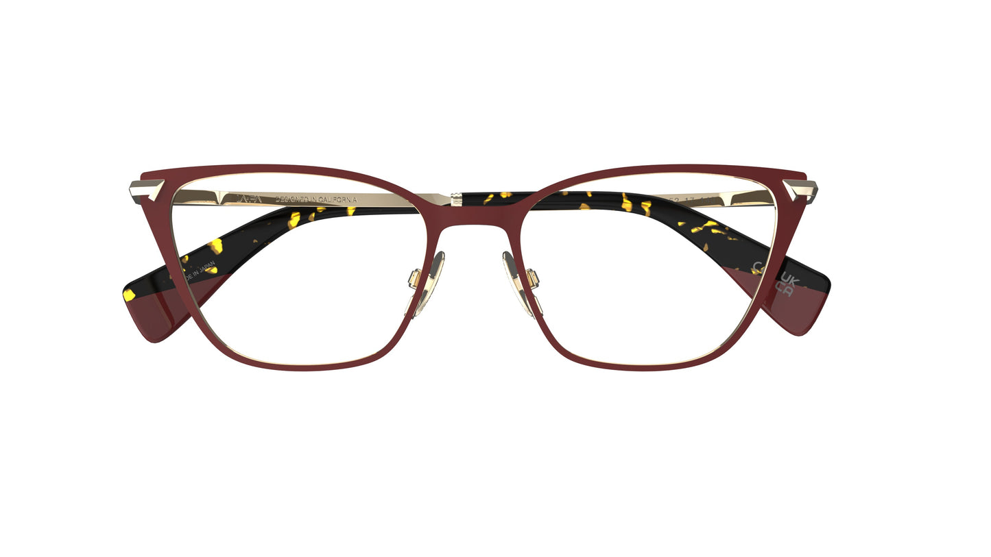 A pair of cat-eye eyeglasses with a burgundy red titanium frame, gold nosepads, and tortoiseshell temple tips, shown against a plain white background.