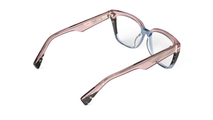 A rear view of a pair of cat-eye oversized square eyeglasses featuring a translucent pink acetate frame that transitions into a blue gradient at the bottom, with tortoiseshell accents. Geometric patterned wire cores.