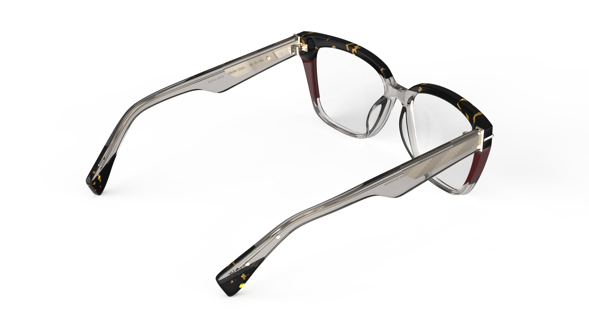 A rear view of a pair of square eyeglasses featuring a translucent warm gray acetate front with dark tortoiseshell browns and burgundy accent, and matching warm gray temples with geometric patterned metal wire core.
