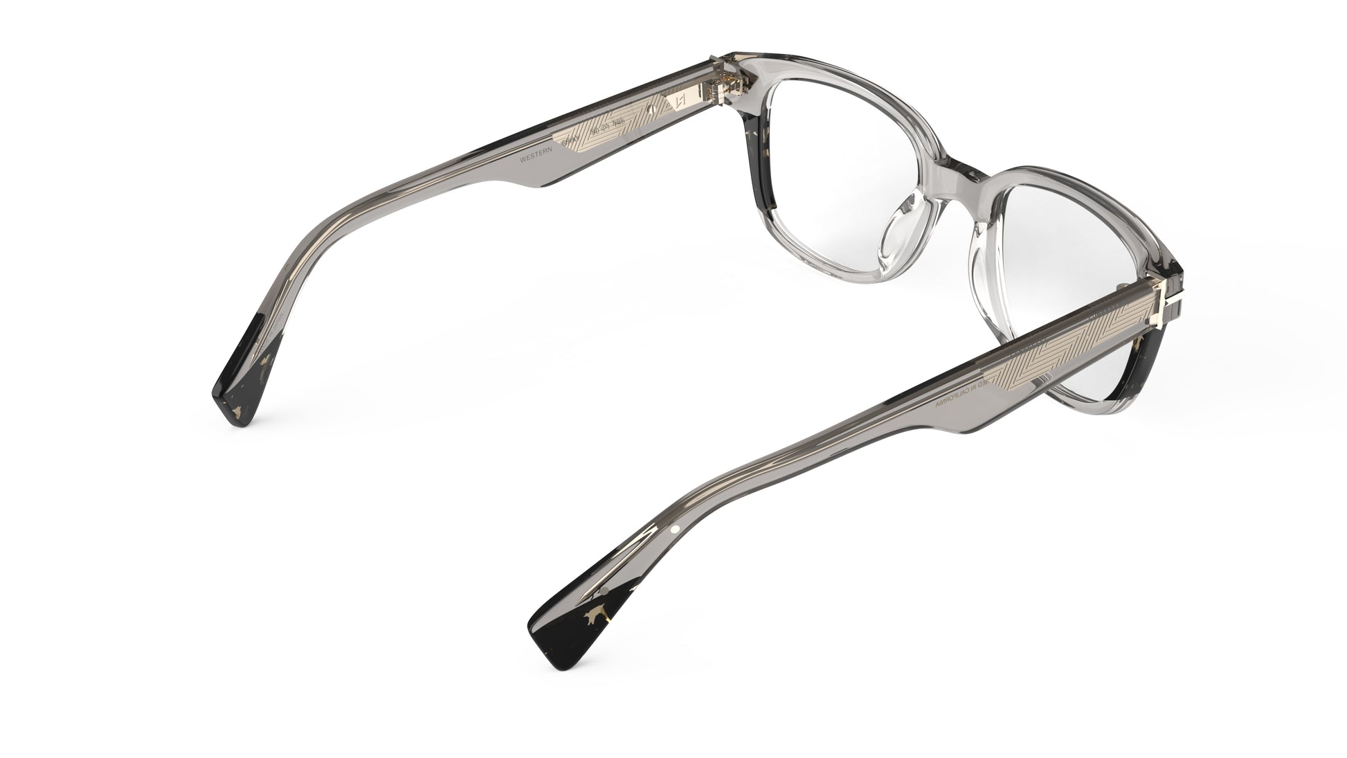 A rear view of a  pair of warm gray acetate eyeglass frames with smoky tortoise accents, geometric patterned metal wire core, seen on a solid white background.